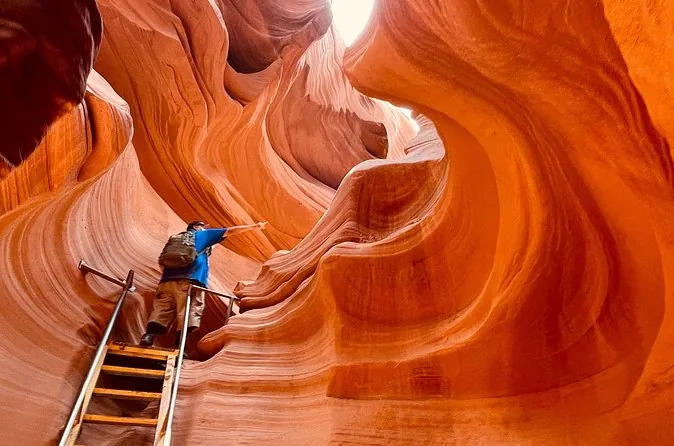 A visitor on a steel staircase inside Lower Antelope Canyon