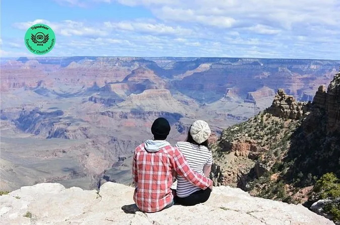 Two travelers sitting on the rim of the Grand Canyon